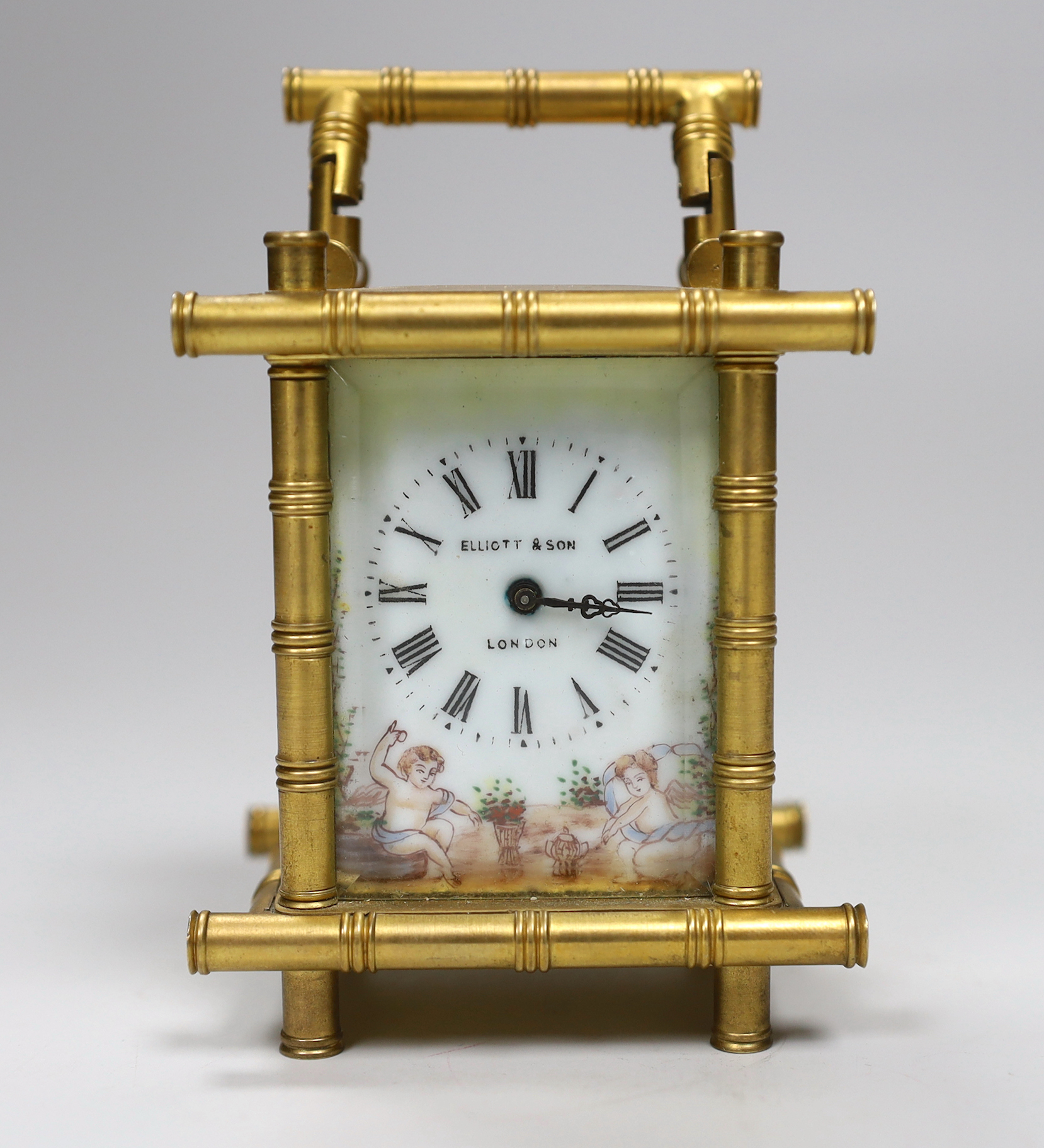 A French bamboo design carriage clock, with three porcelain putti decorated sides, by Elliot & Son, London, 9.5cm high